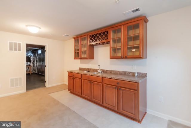 kitchen with light colored carpet and sink