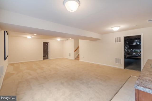 basement featuring light carpet