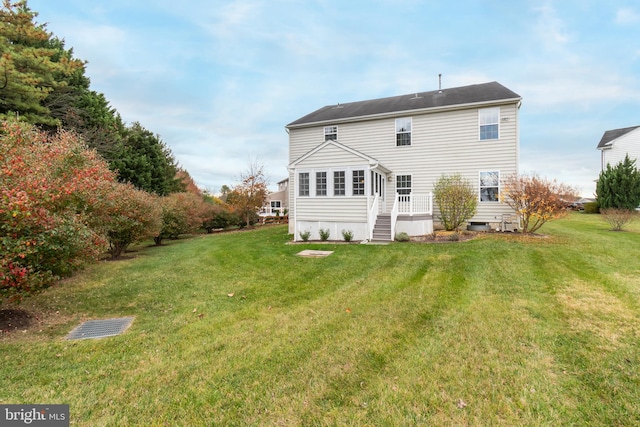 back of house with a lawn