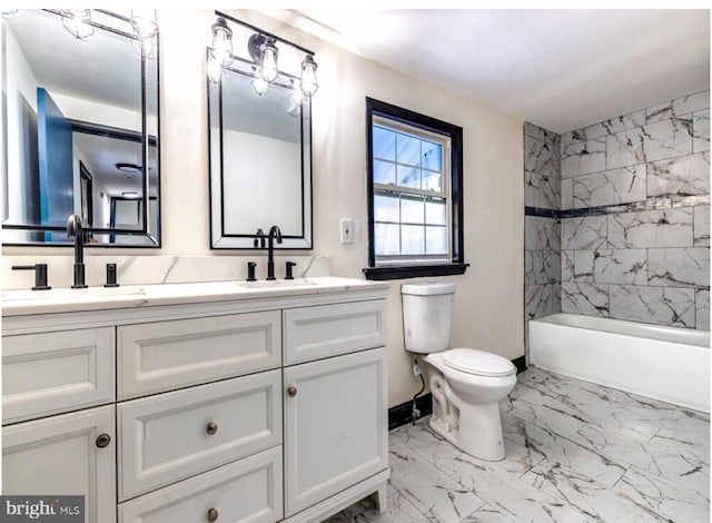 full bathroom featuring toilet, vanity, and tiled shower / bath