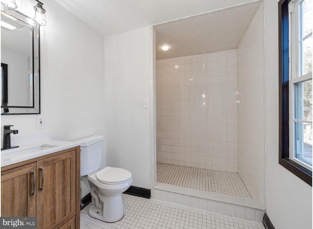 bathroom with a tile shower, a wealth of natural light, tile patterned flooring, and toilet