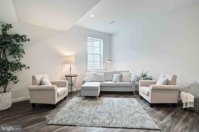 living room with lofted ceiling and dark wood-type flooring