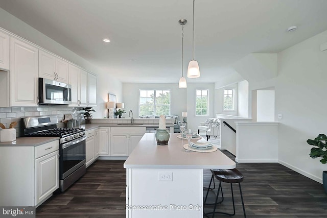 kitchen featuring sink, white cabinets, stainless steel appliances, and dark hardwood / wood-style floors