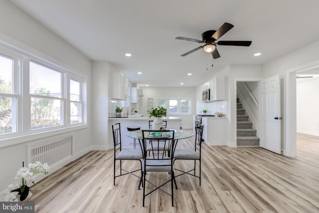 dining area featuring light hardwood / wood-style floors, ceiling fan, and a healthy amount of sunlight