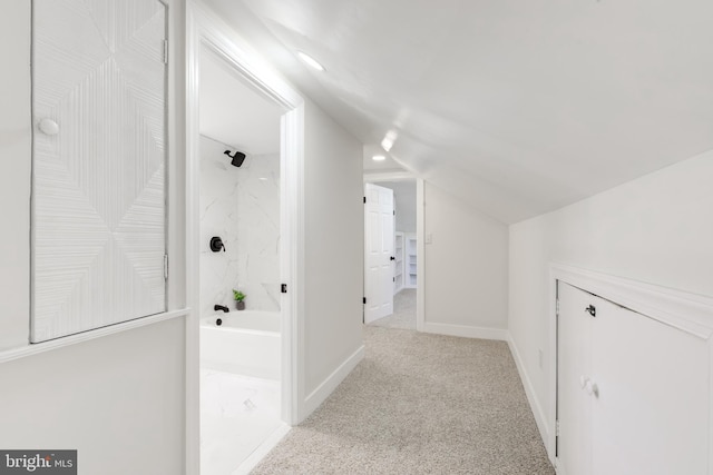 bonus room with light carpet and vaulted ceiling