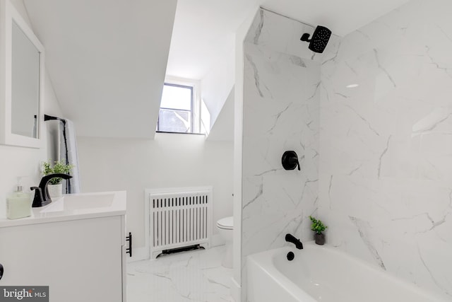 full bathroom with toilet, radiator, tiled shower / bath, and vanity