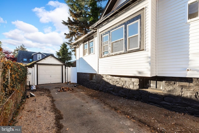 view of home's exterior with a garage and an outdoor structure