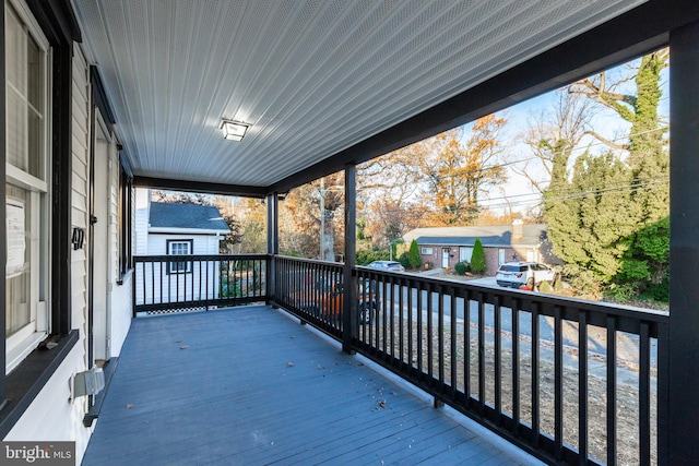 wooden terrace featuring covered porch