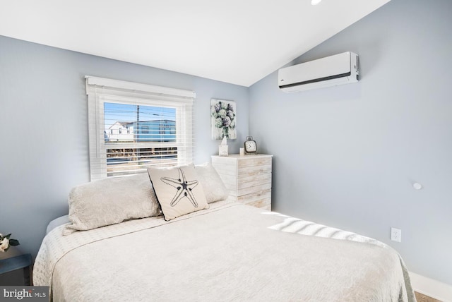 bedroom featuring a wall mounted AC and vaulted ceiling