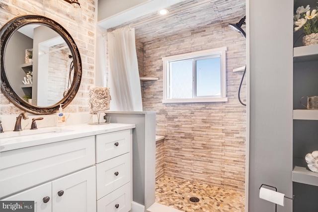 bathroom featuring vanity and a tile shower