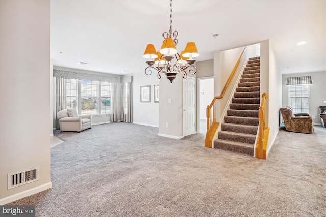 unfurnished living room with carpet flooring and a chandelier