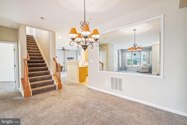 interior space featuring light colored carpet and a chandelier