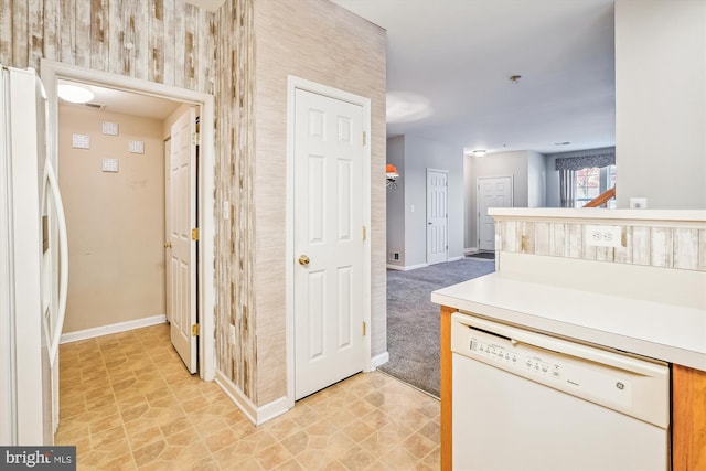 kitchen featuring light colored carpet and white appliances