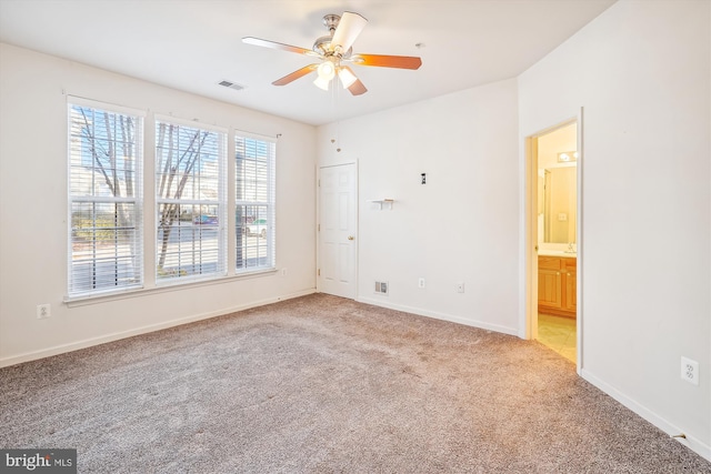 unfurnished room featuring light carpet and ceiling fan