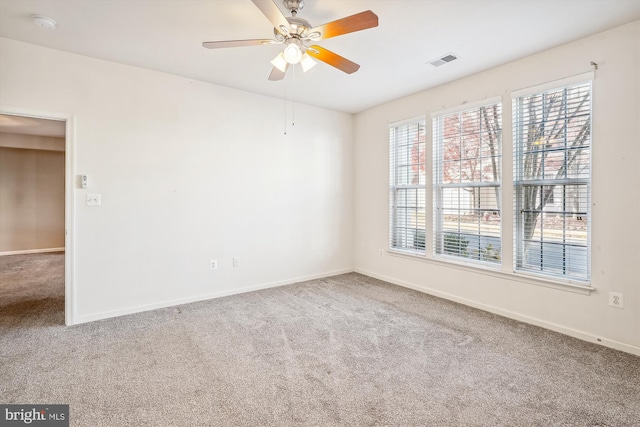 spare room featuring carpet flooring and ceiling fan