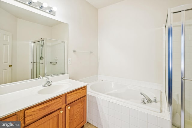 bathroom with vanity and separate shower and tub