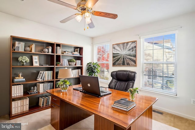 home office with ceiling fan and a healthy amount of sunlight