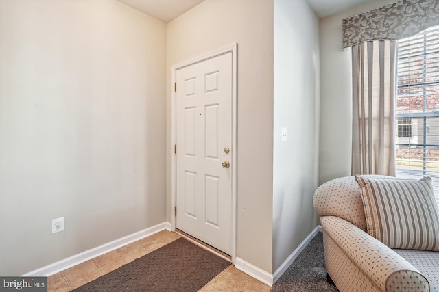 entryway with light tile patterned flooring