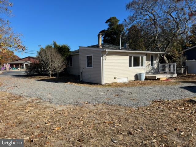 back of house with a wooden deck