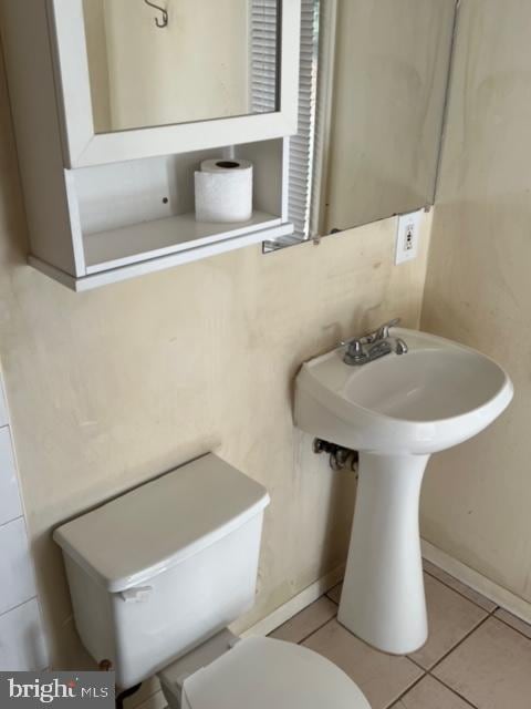 bathroom with tile patterned floors and toilet