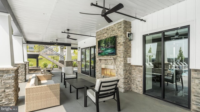 view of patio / terrace with ceiling fan and an outdoor stone fireplace