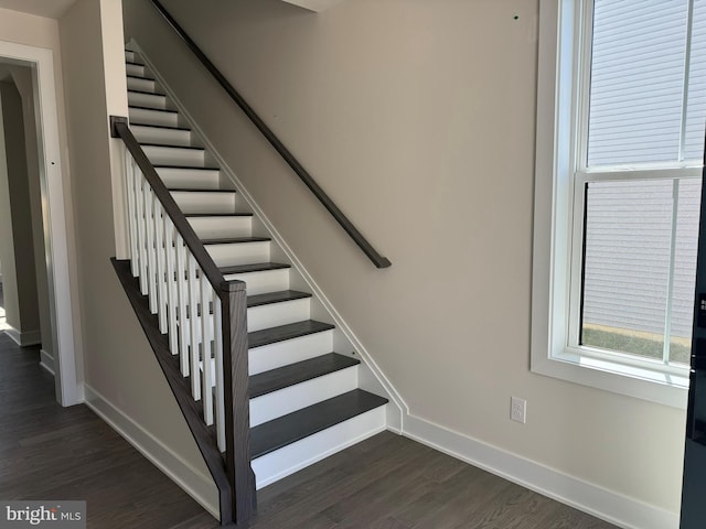 stairs featuring hardwood / wood-style floors