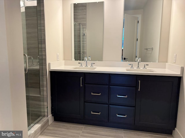 bathroom featuring a shower with door, vanity, and wood-type flooring