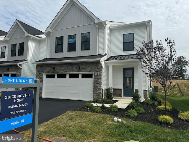 townhome / multi-family property featuring a garage, central AC unit, and a front lawn