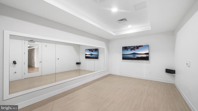 unfurnished room featuring hardwood / wood-style floors and a raised ceiling