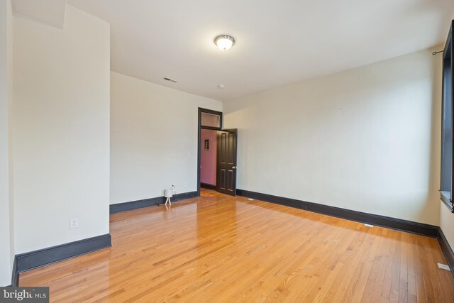 unfurnished room with light hardwood / wood-style floors