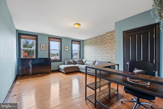 415 E Lafayette Ave, Baltimore, MD 21202 - living room with a desk, baseboards, wood finished floors, and an accent wall