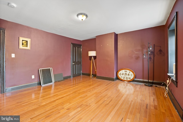 415 E Lafayette Ave, Baltimore, MD 21202 - spare room featuring wood-type flooring, a smoke detector, and baseboards