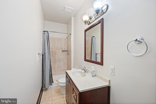 bathroom featuring tile patterned flooring, vanity, curtained shower, and toilet