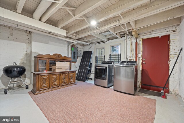 basement featuring electric panel and independent washer and dryer