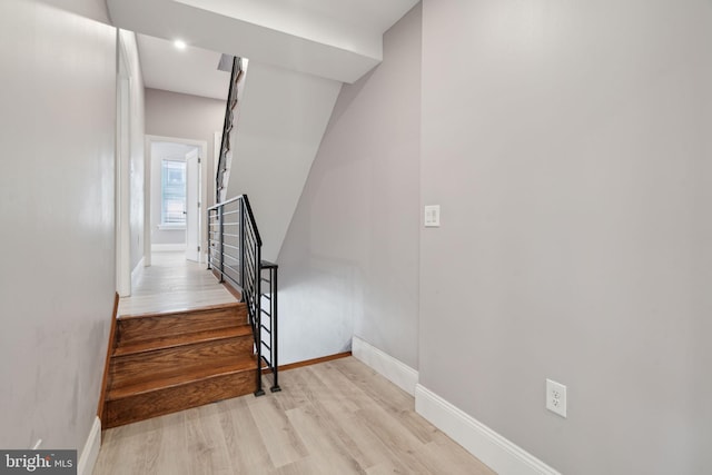 stairs featuring hardwood / wood-style flooring