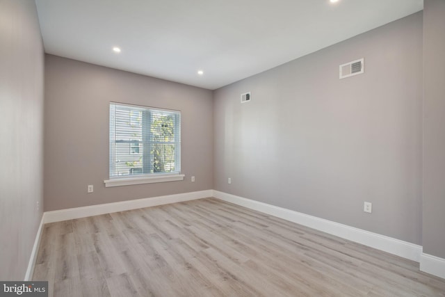 empty room with light hardwood / wood-style flooring