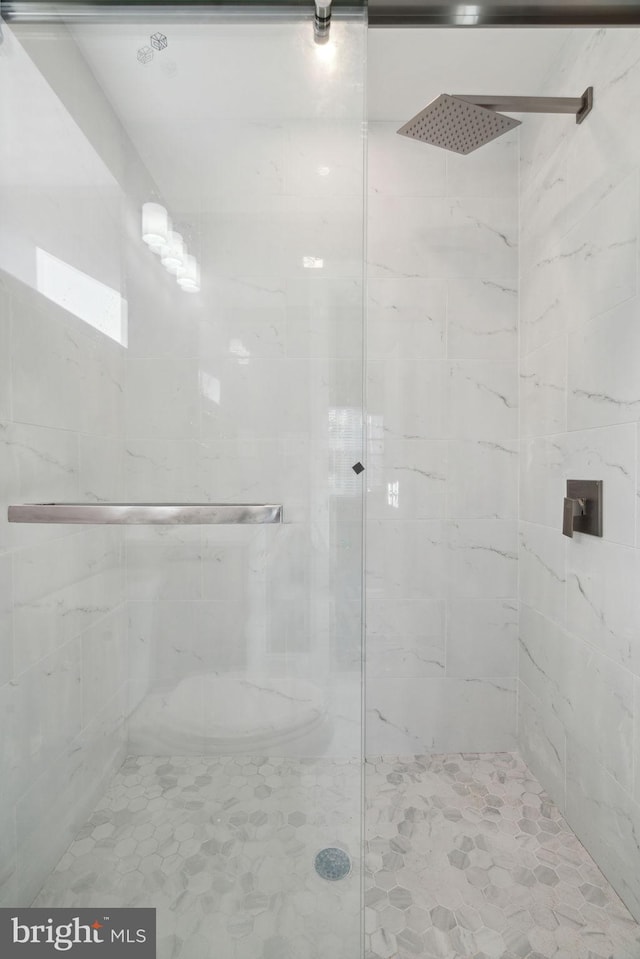 bathroom with a shower with door