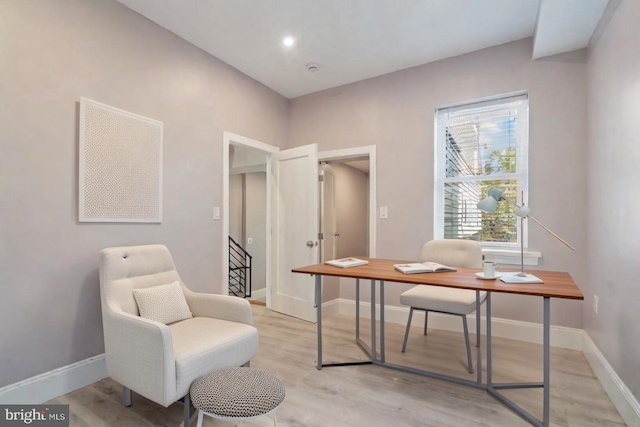 home office with light hardwood / wood-style floors