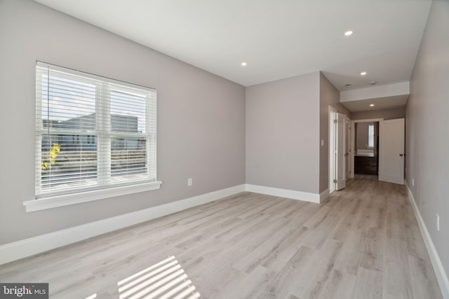 spare room with light hardwood / wood-style flooring