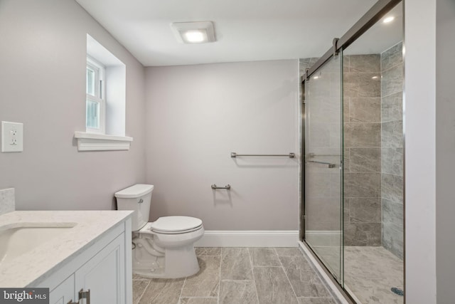 bathroom featuring walk in shower, vanity, and toilet