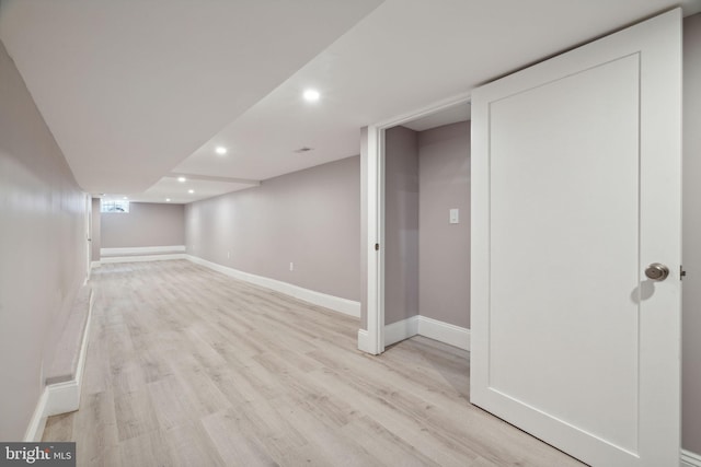 basement featuring light hardwood / wood-style floors