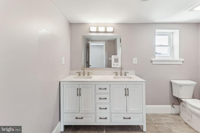 1325 S 15th St, Philadelphia, PA 19146 - bathroom with toilet, baseboards, and double vanity