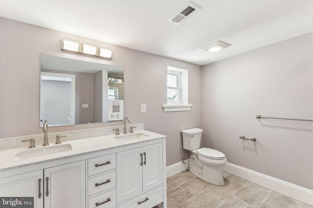 1325 S 15th St, Philadelphia, PA 19146 - bathroom with toilet, baseboards, and double vanity