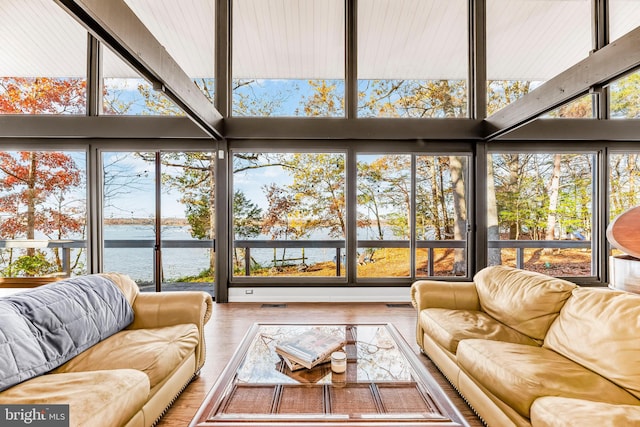 sunroom / solarium with a water view