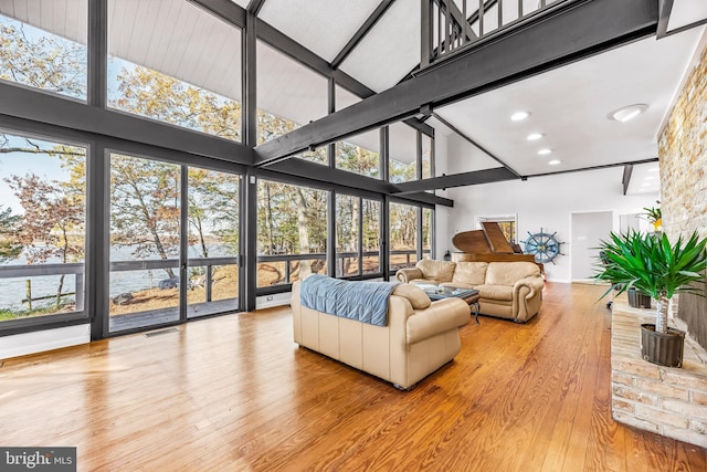 sunroom / solarium with vaulted ceiling with beams