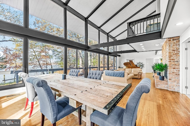 sunroom / solarium featuring vaulted ceiling