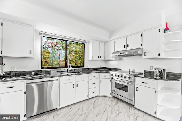 kitchen with white cabinets, stainless steel appliances, dark stone countertops, and sink