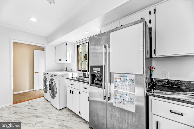 clothes washing area featuring washing machine and clothes dryer and sink