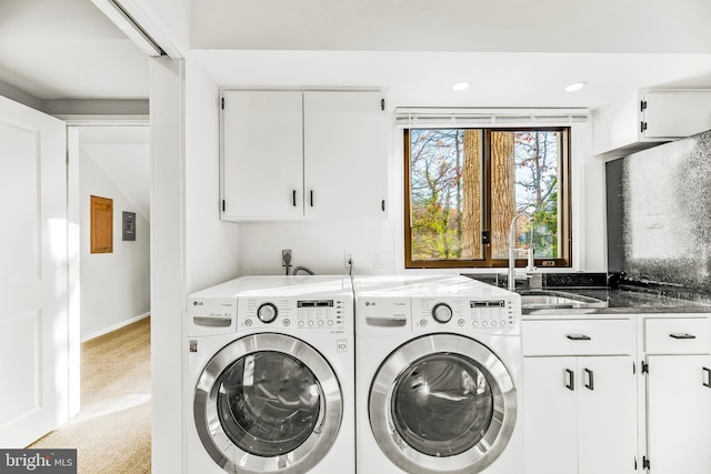 laundry area with cabinets, sink, light carpet, and washing machine and clothes dryer