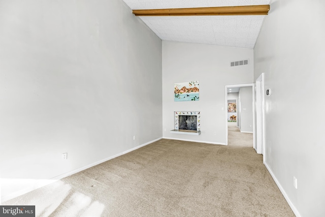 unfurnished living room with light carpet, beamed ceiling, high vaulted ceiling, and a textured ceiling